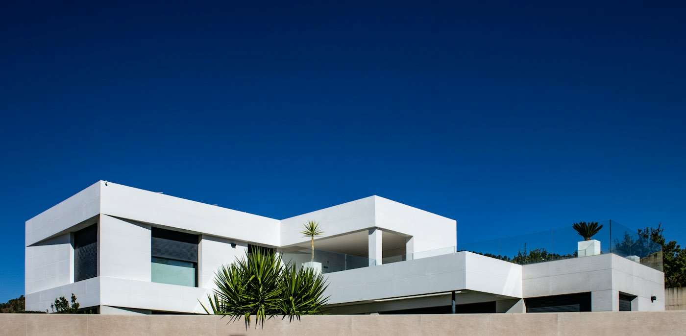 Modern flat-roofed house under a blue sky