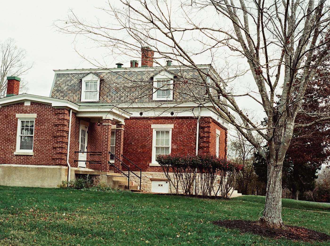 Historic brick house with a slate-clad mansard roof